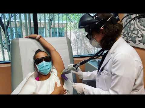 Dr. Rebecca Baxt performs laser hair removal on patient's underarms