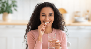 Woman with brittle nails holding a glass