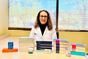 Dr. Baxt with boxes of dermal fillers